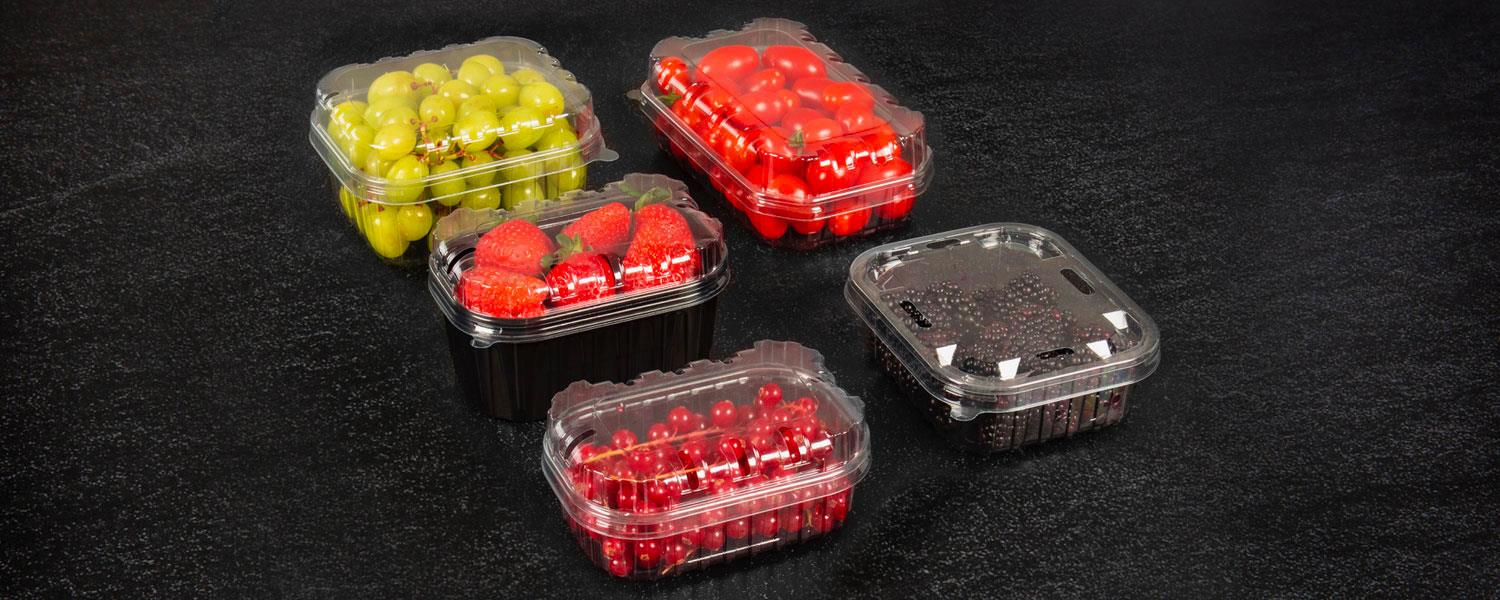 100& rPET packaging lids with raspberries, strawberries and grapes on a black background